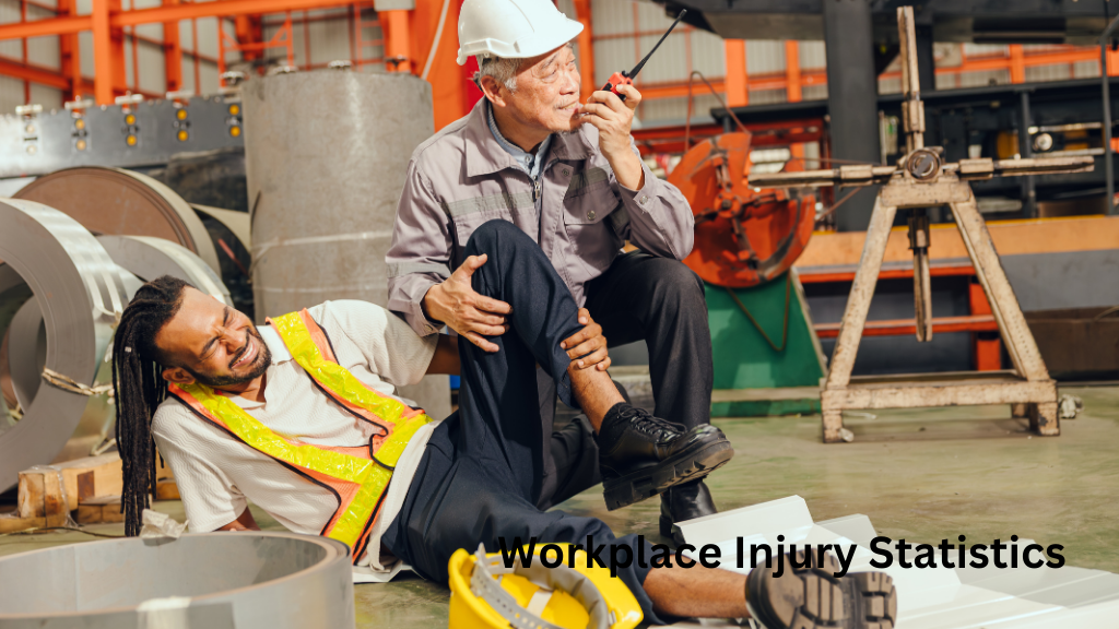 Workplace injury at a factory where a construction worker wearing a safety vest receives assistance from a supervisor after a job-site accident.