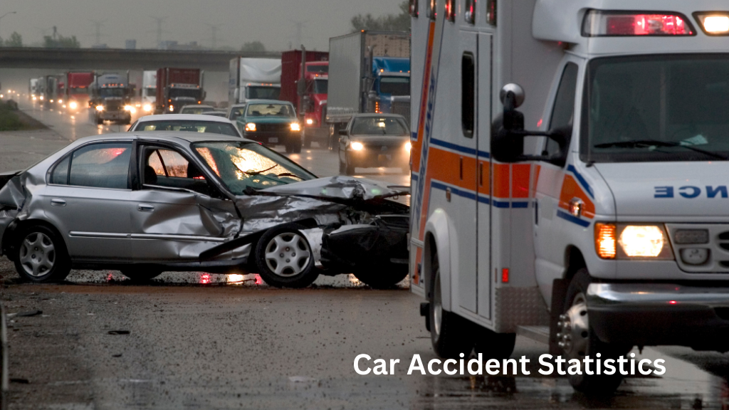 Damaged car after a highway crash with an ambulance arriving at the scene, illustrating car accident statistics and road safety risks.