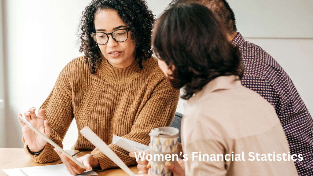 Women reviewing financial documents and using a tablet during a discussion about budgeting and financial planning, illustrating women’s financial statistics.